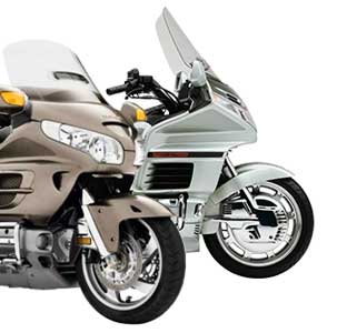 Photo of a green GL-1500 and tan GL-1800 Honda Gold Wing motorcycles